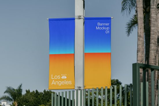 Outdoor banner mockup on a light post with a gradient design, showcasing clear skies and palm trees in Los Angeles, ideal for designers' presentations.